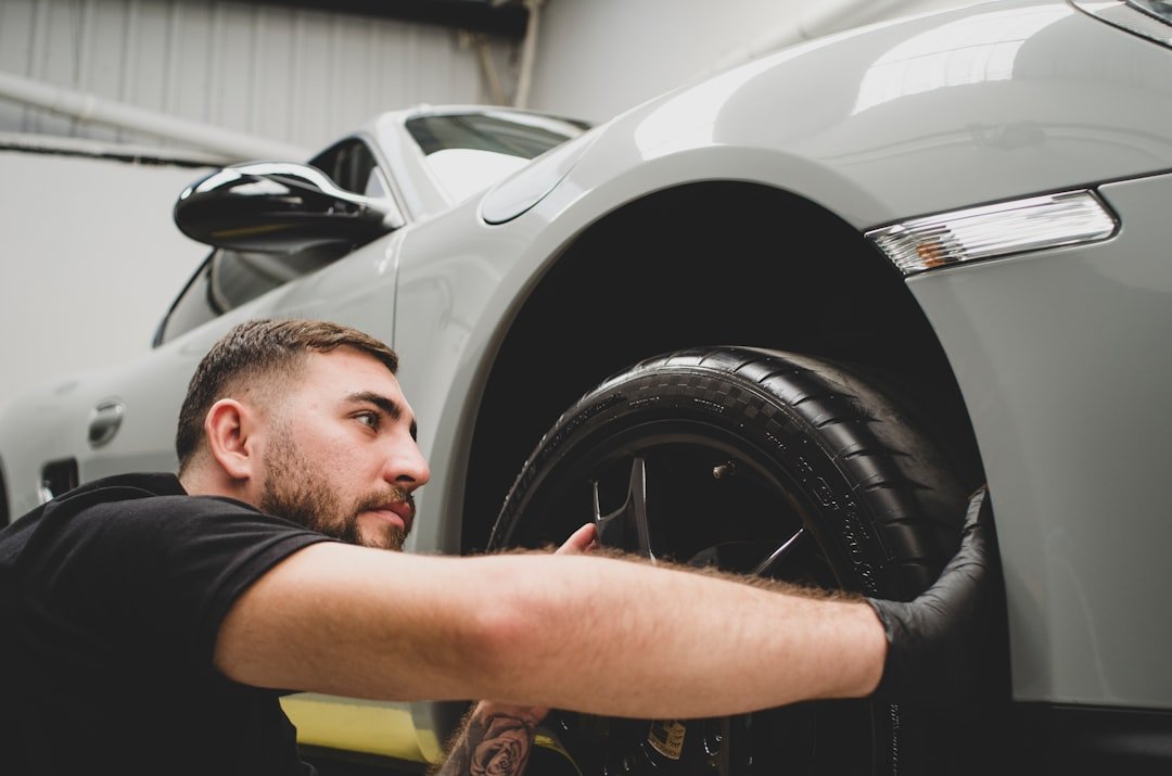 a-man-working-on-a-car-in-a-garage-0uehgwsfyhm