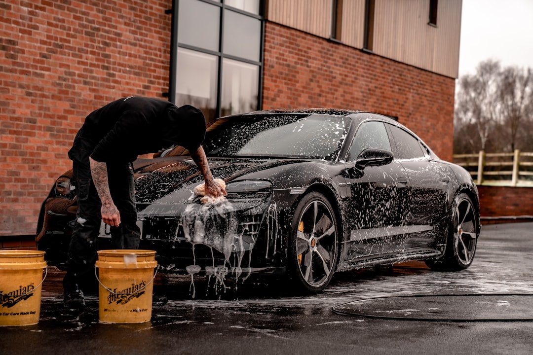 man-in-black-t-shirt-and-black-pants-doing-water-splash-on-black-coupe-during-daytime-ep8h7yvhfhk