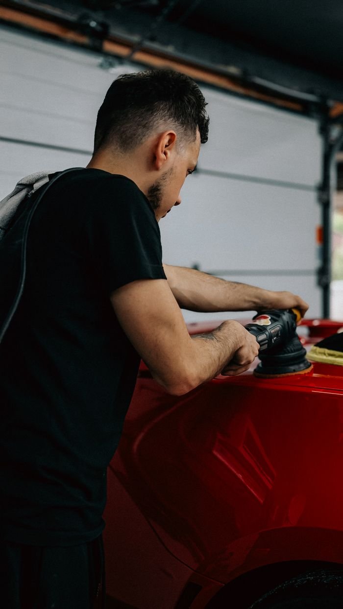 Machine polishing a red car